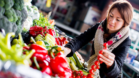 Young lady purchasing vegetable