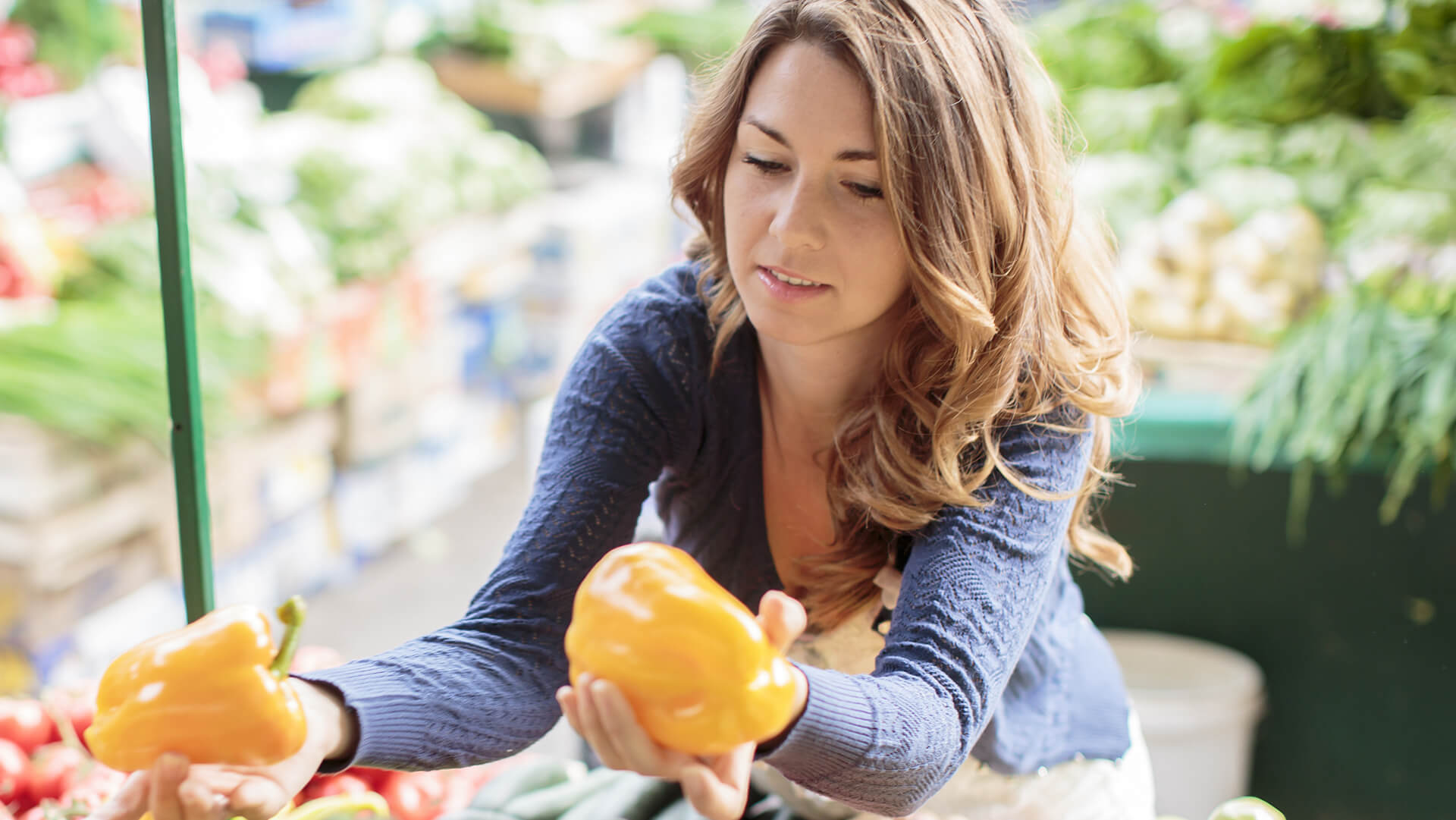 A lady testing a quality of capsicum